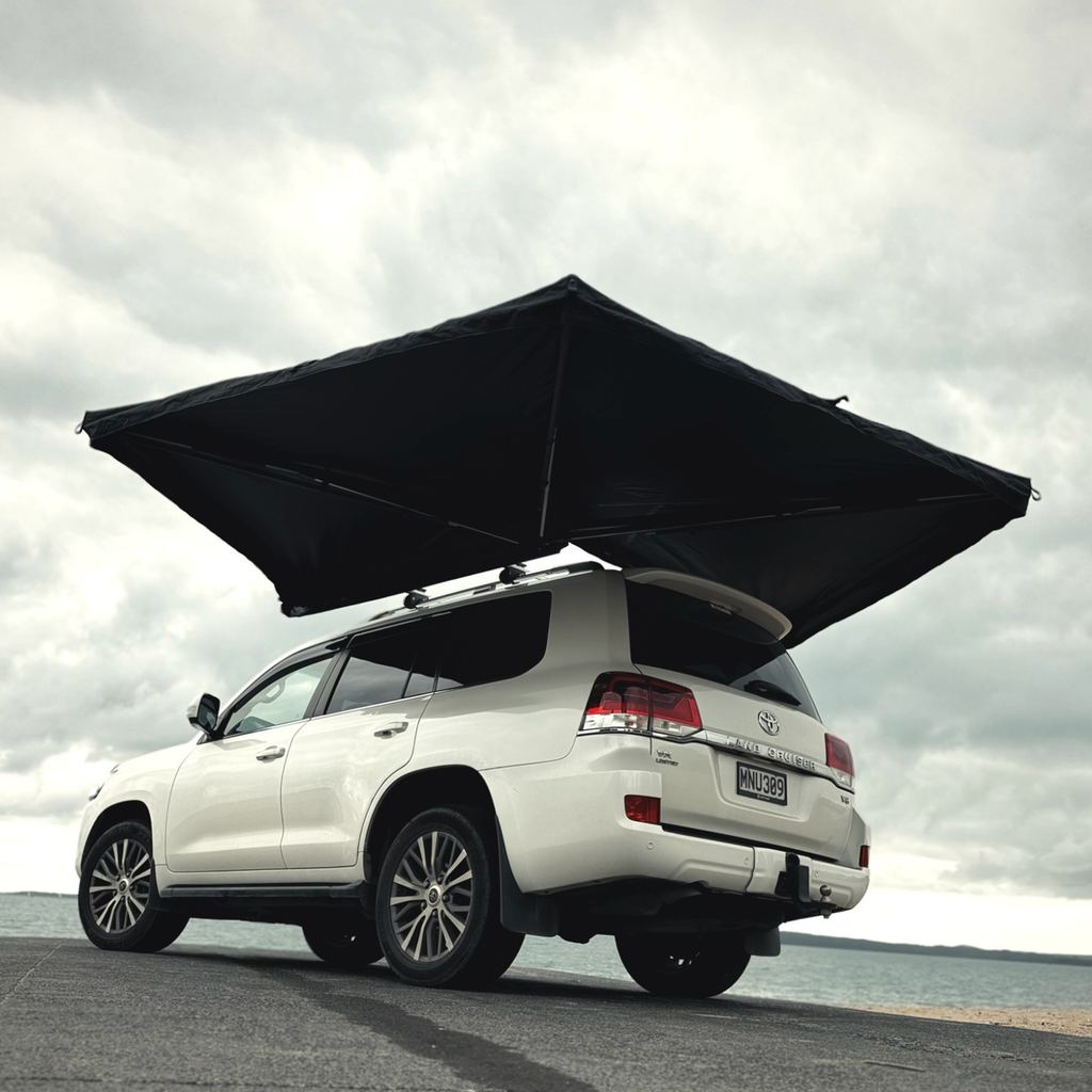 Stoke Mako 270 awning wrapping 270 degrees around the side and rear of a 4WD at the coast