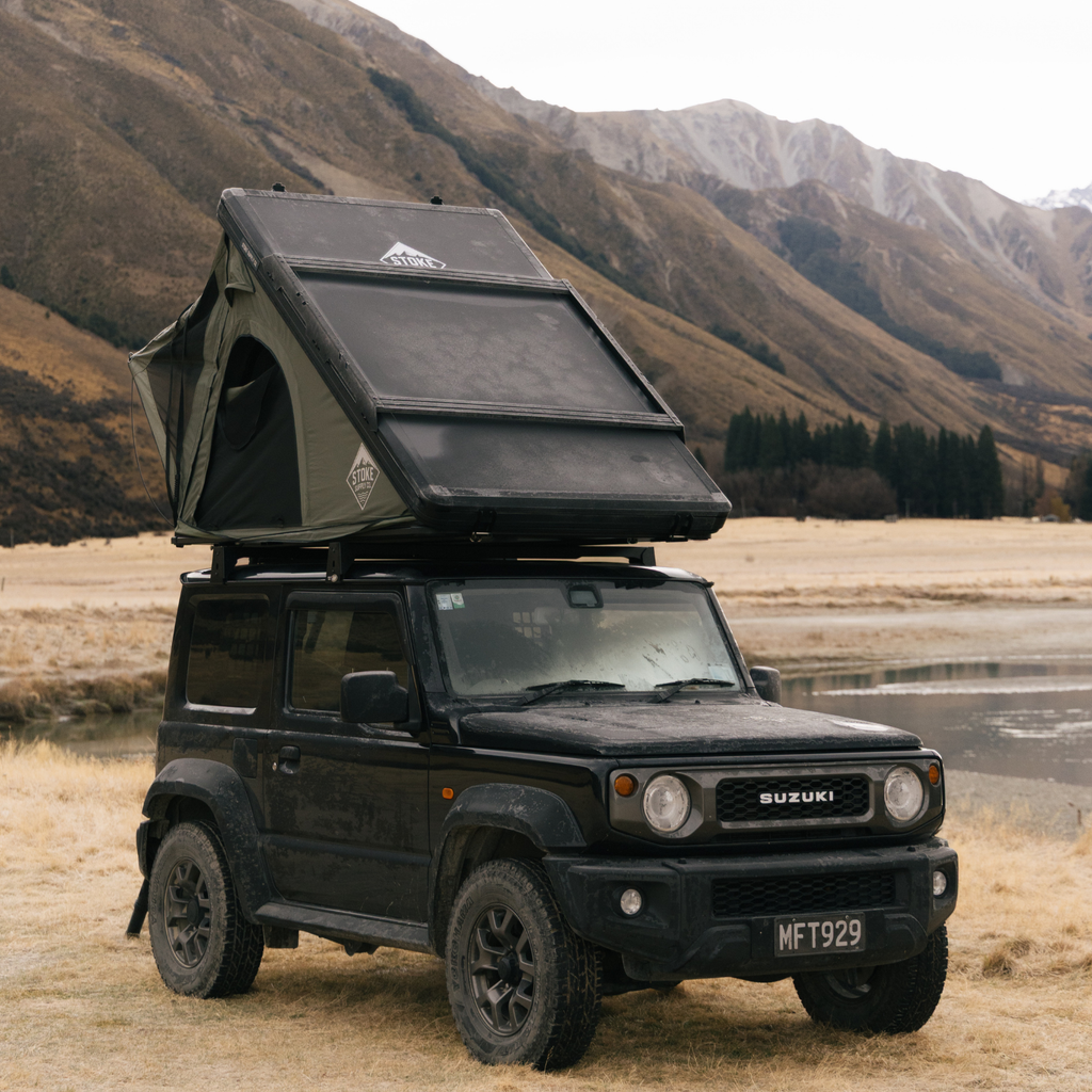 Stoke STEALTH hard-shell rooftop tent mounted on a Suzuki Jimny in the Southern Alps, New Zealand