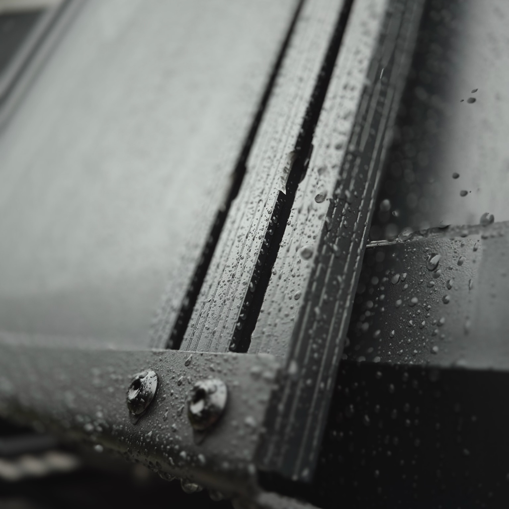 Close-up of the mounting bolts securing a Stoke slimline crossbar into the rooftop tent T-channel