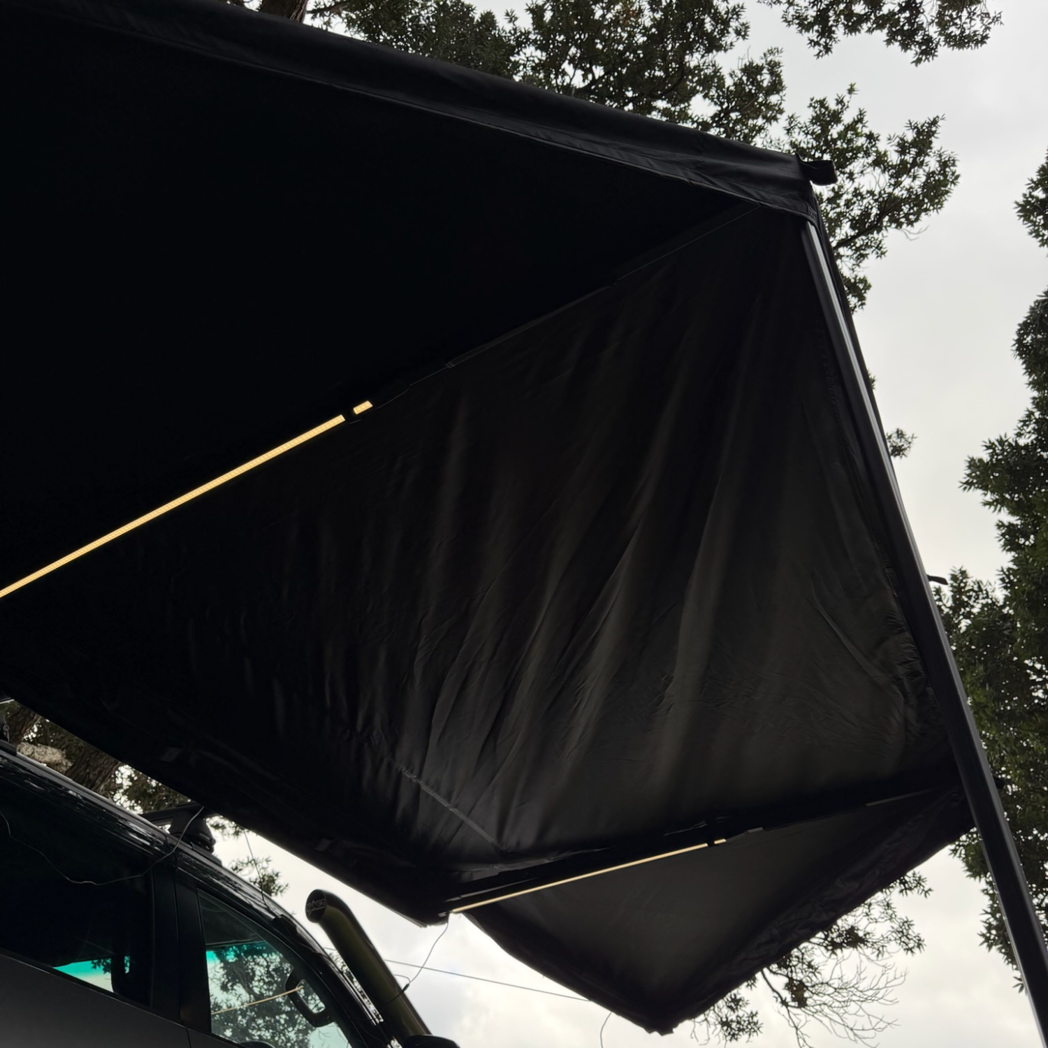Stoke Mako 180 awning fully fanned open in its 180-degree batwing layout