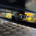 Stoke Quick Release Tent Bracket mounted under a rooftop tent on vehicle roof bars, latch engaged